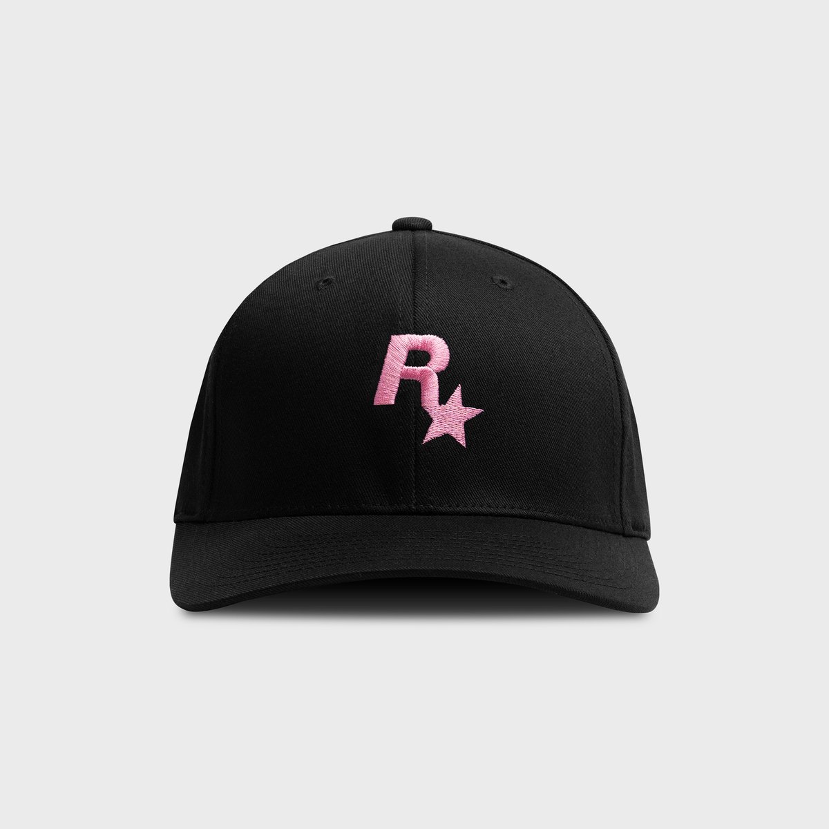 Black Rockstar cap from the GTA 6 collection with the Rockstar Games logo embroidered in pink on the front
