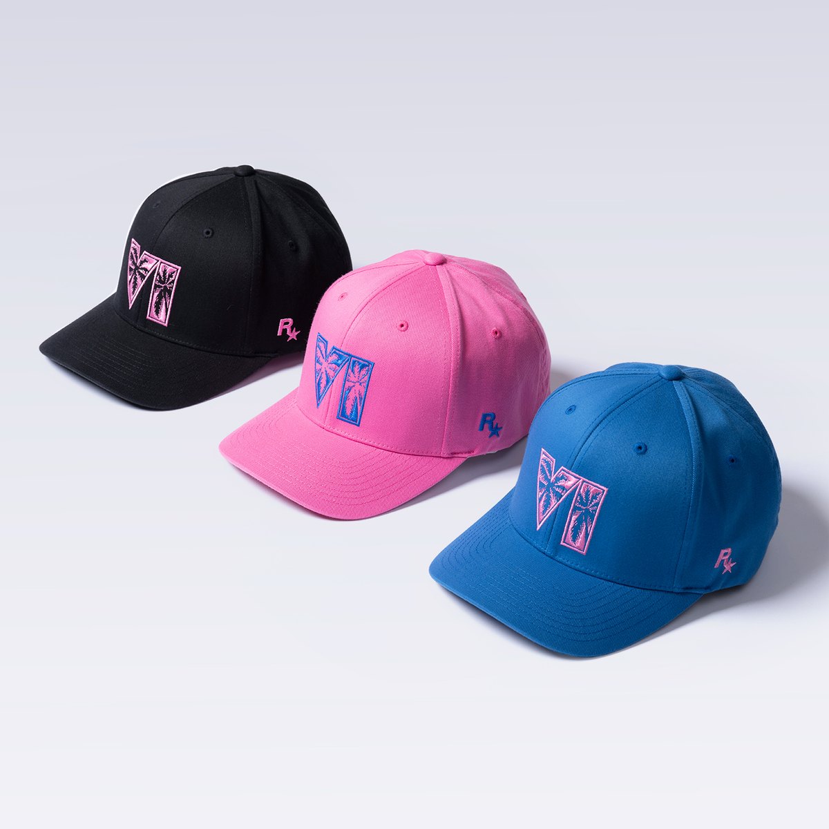 Three GTA 6 caps in black, pink and blue, embroidered with the VI palm tree logo and the Rockstar Games logo