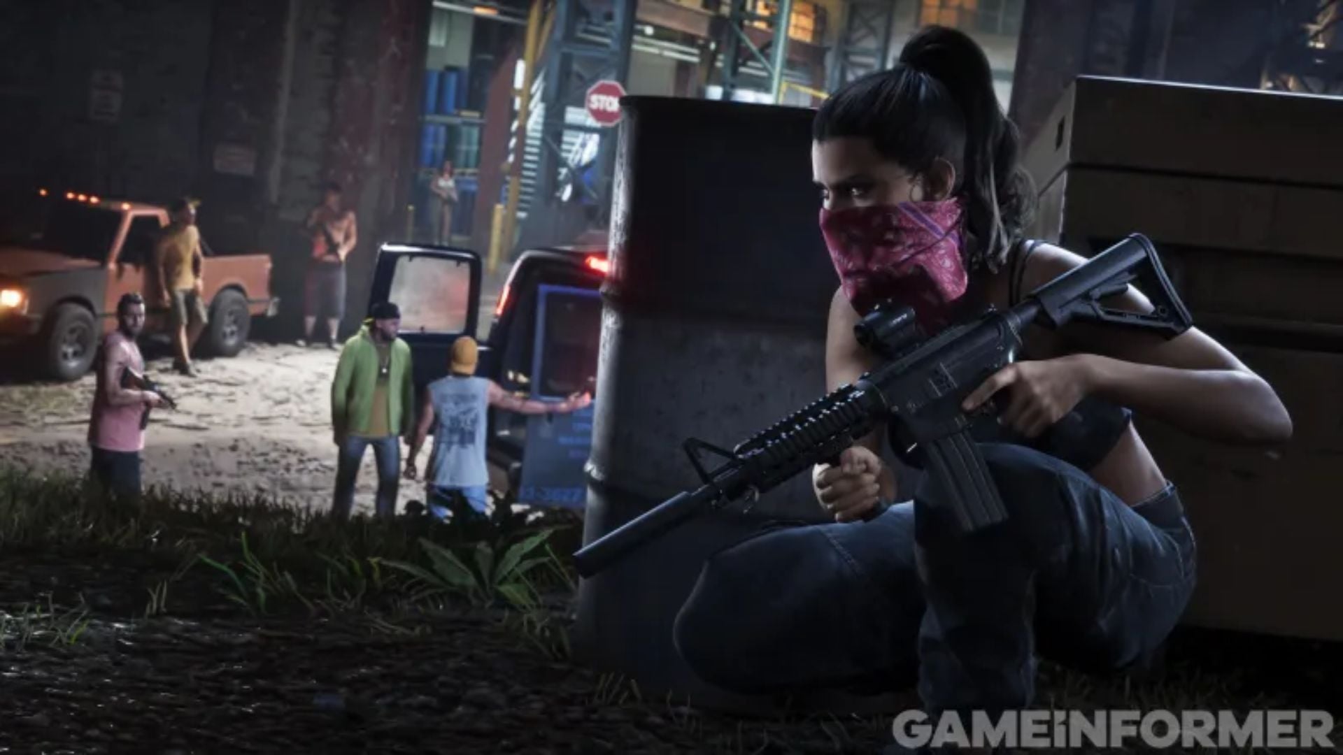 Lucia, masked with a bandana, crouches behind a barrel with an assault rifle, watching a group in GTA 6