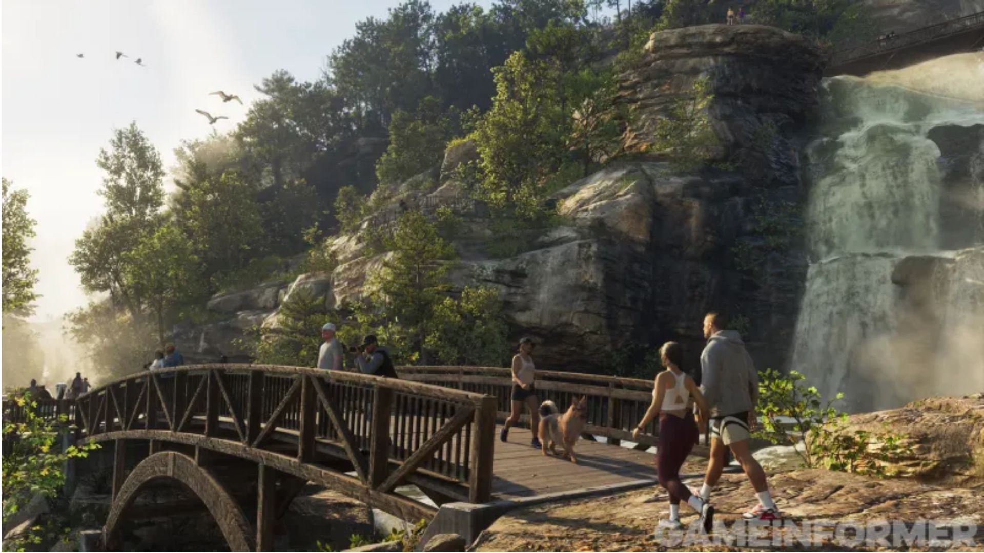 Hikers and a dog cross a wooden footbridge next to a large waterfall and rocky cliffs in GTA 6