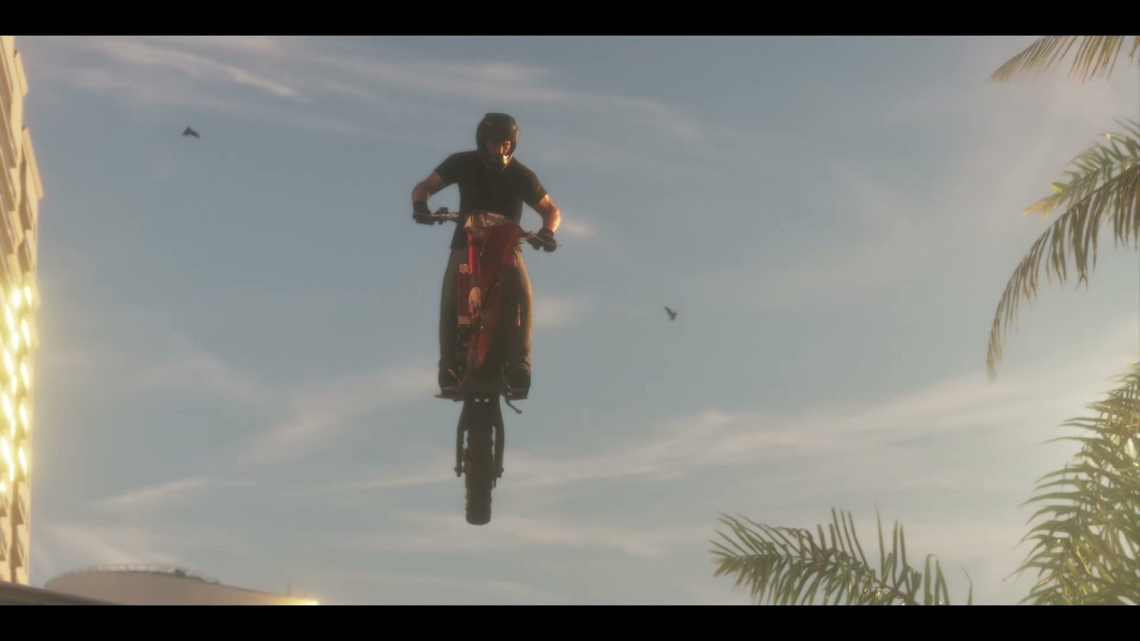 A rider soars into the sky on a red motorbike above the palm trees, GTA 6 launch trailer
